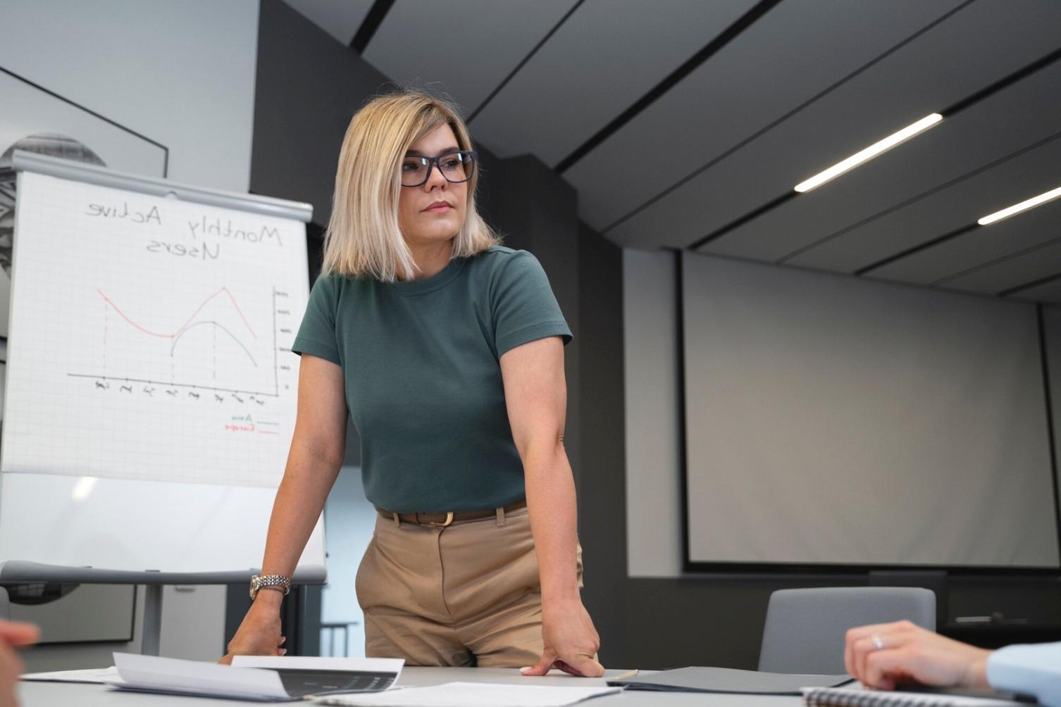 Team members examining financial documents spread across a conference table